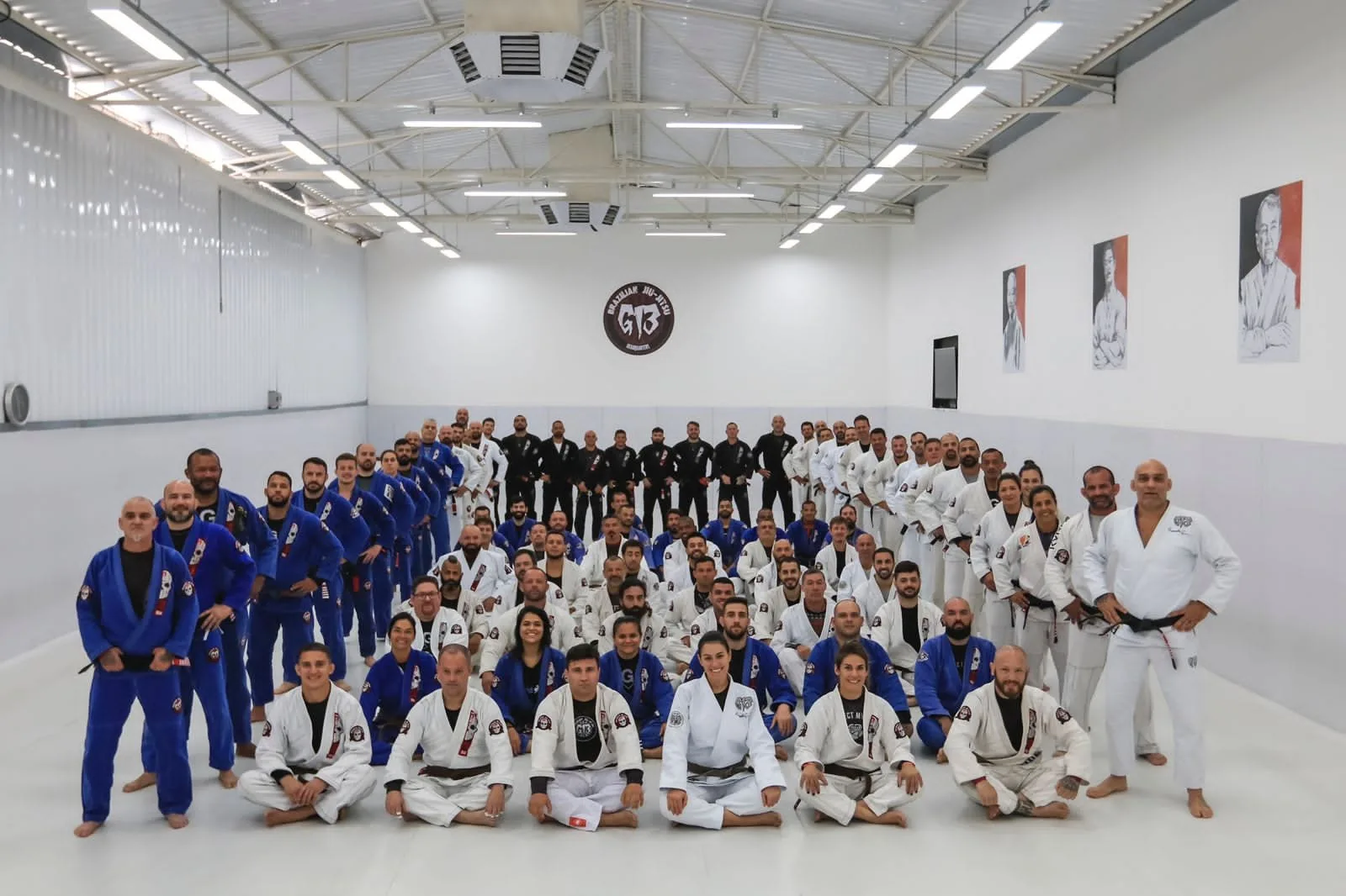 The full team of G13 Cary, North Carolina, lined up on the mat in white and blue gis